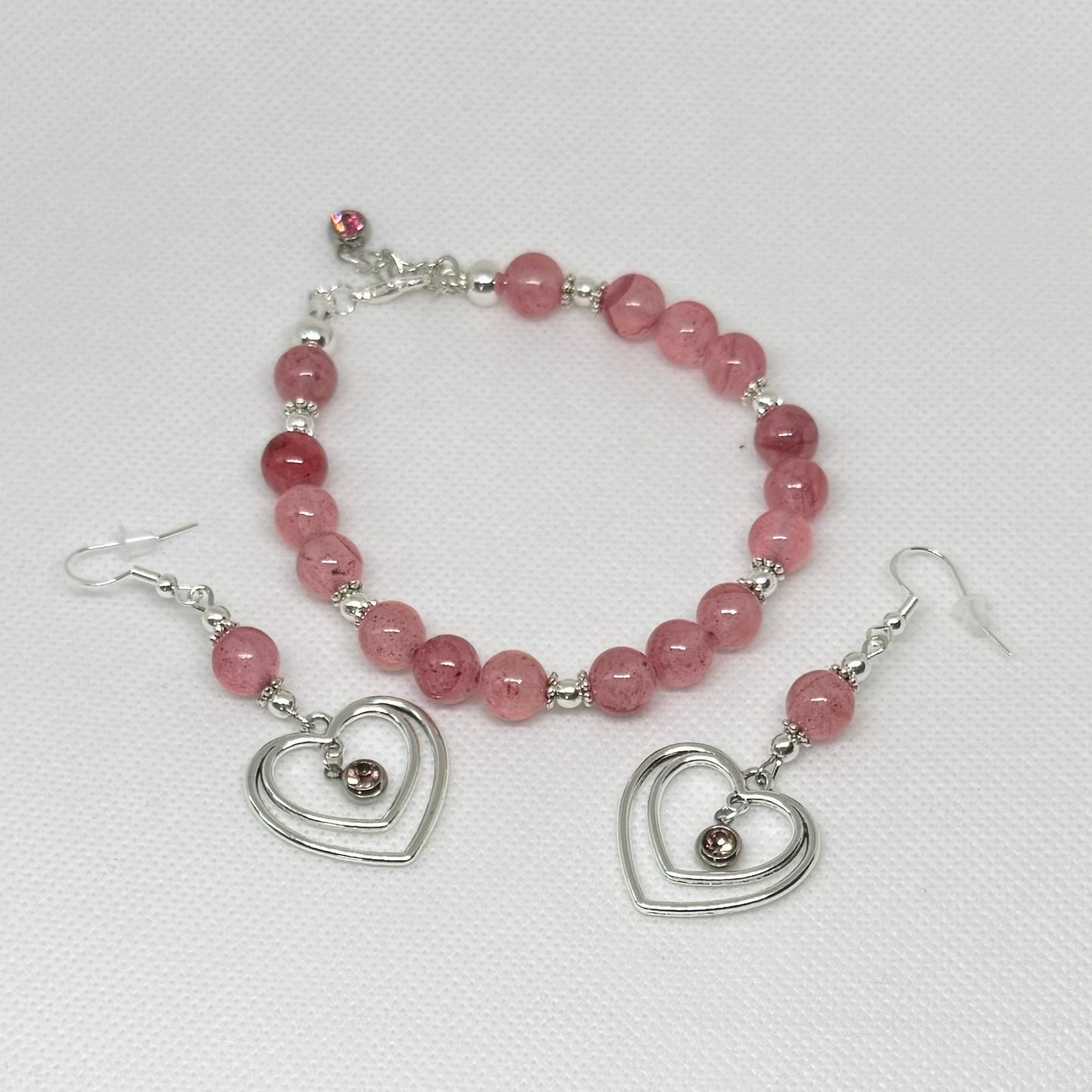 Armbånd og ørepynt i rosa persisk jade og rhinestones