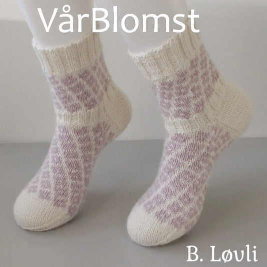 Vårblomst sokker med blomstermotiv i pastellfarger vist på modell